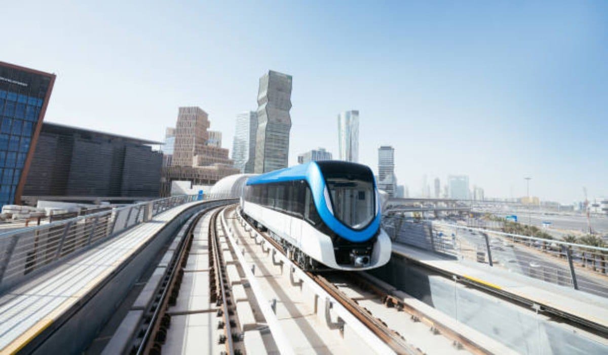 Modern metro train traveling on elevated tracks amidst skyscrapers