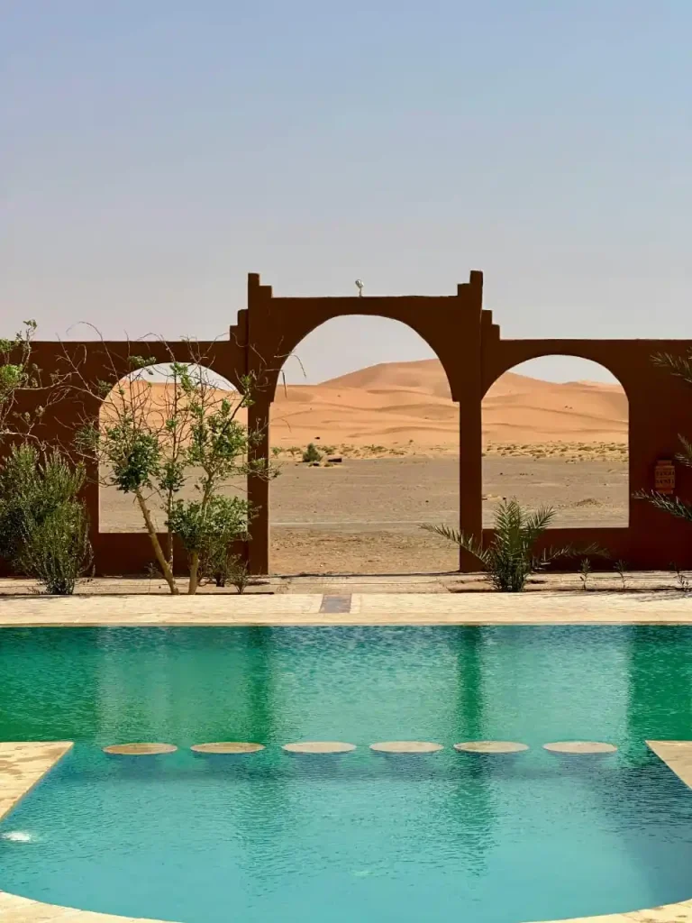 Pool view through desert arches.