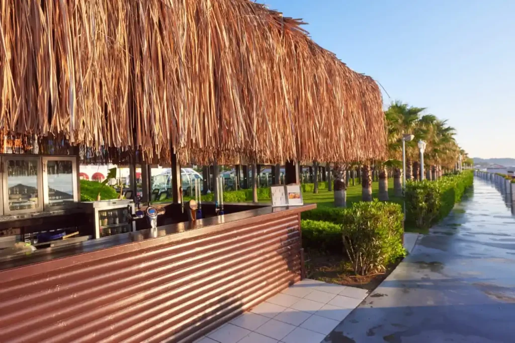 Outdoor beach bar with thatch roof.