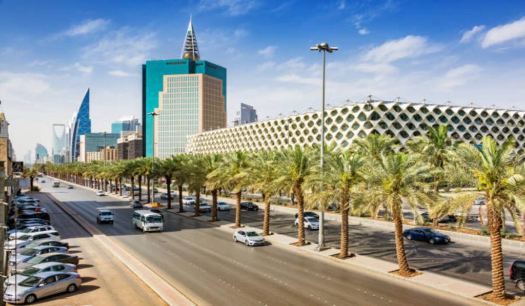 Cars drive past the landmark King Fahd National Library 